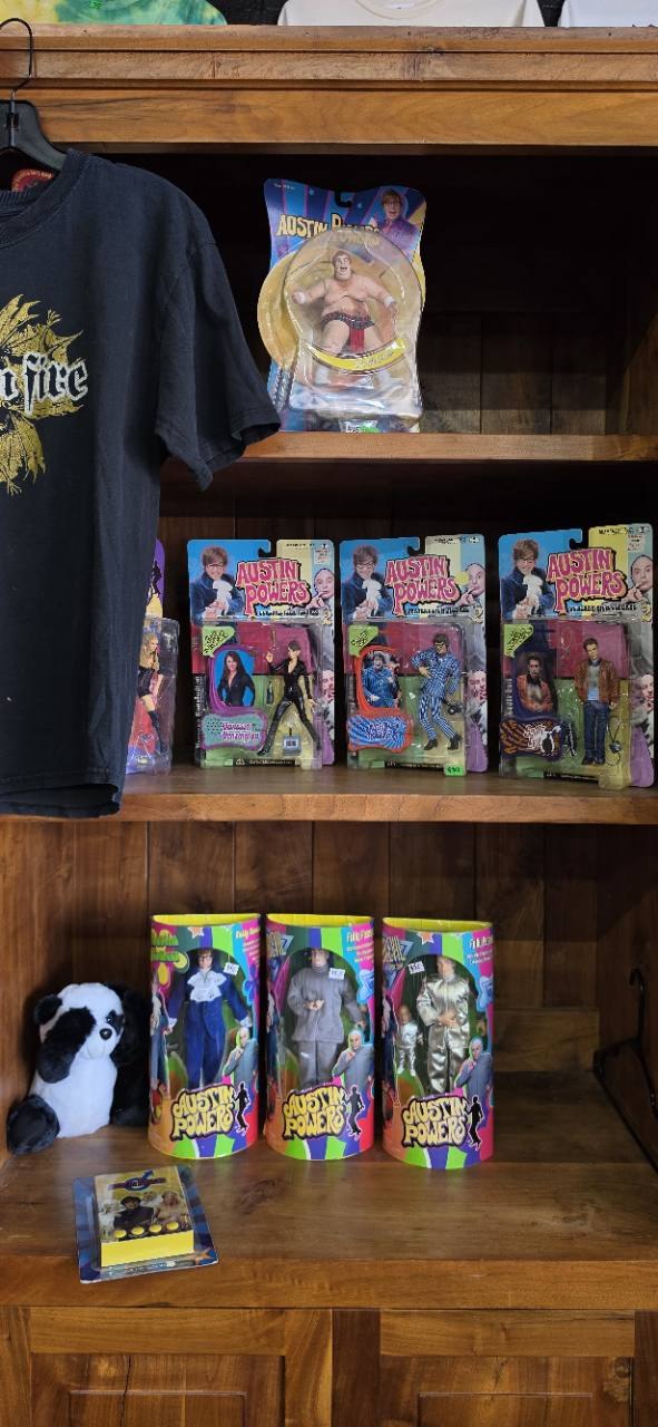 Austin Powers figures and collectibles on wooden shelves